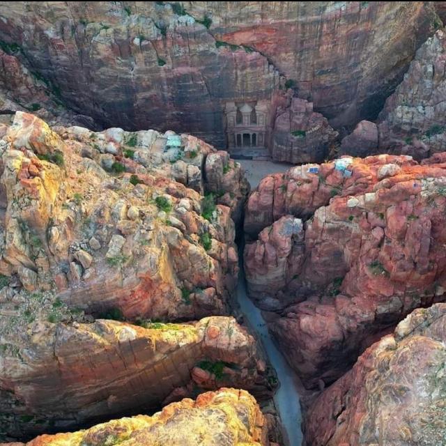 The Siq - Eye Bird View Walking through the Siq gorge in Petra Jordan, leading to Al-Khazneh