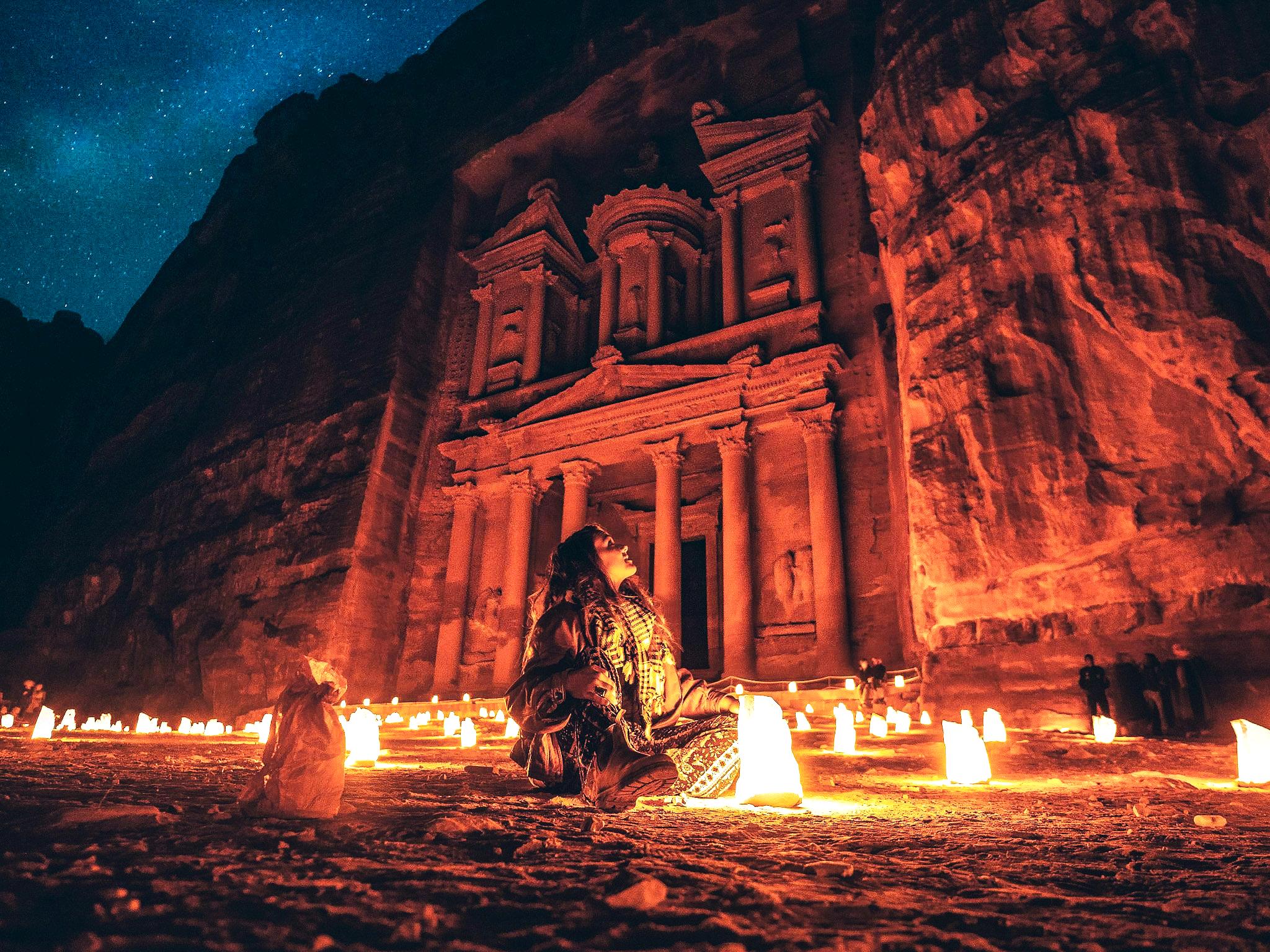 A solo female Traveler Enjoying Petra by night Show